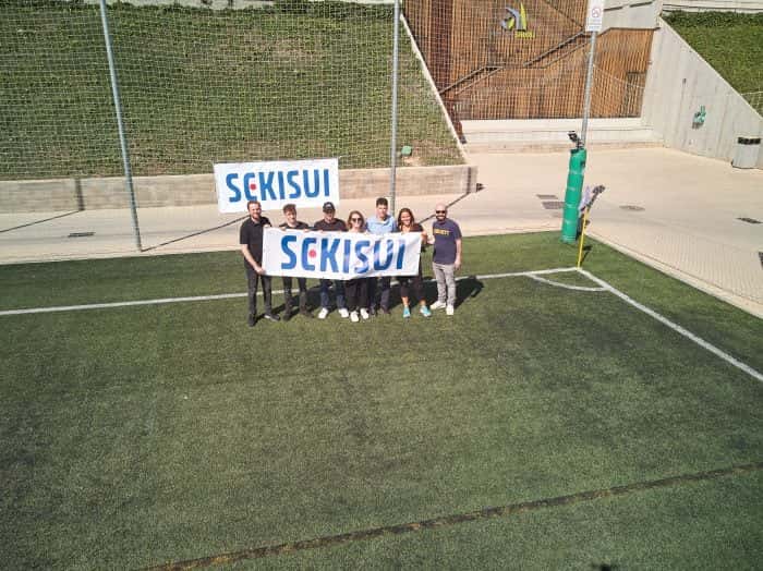 Mitarbeiter von Me & Company halten SEKISUI Banner im Rahmen eines Systemwechsel Projekts